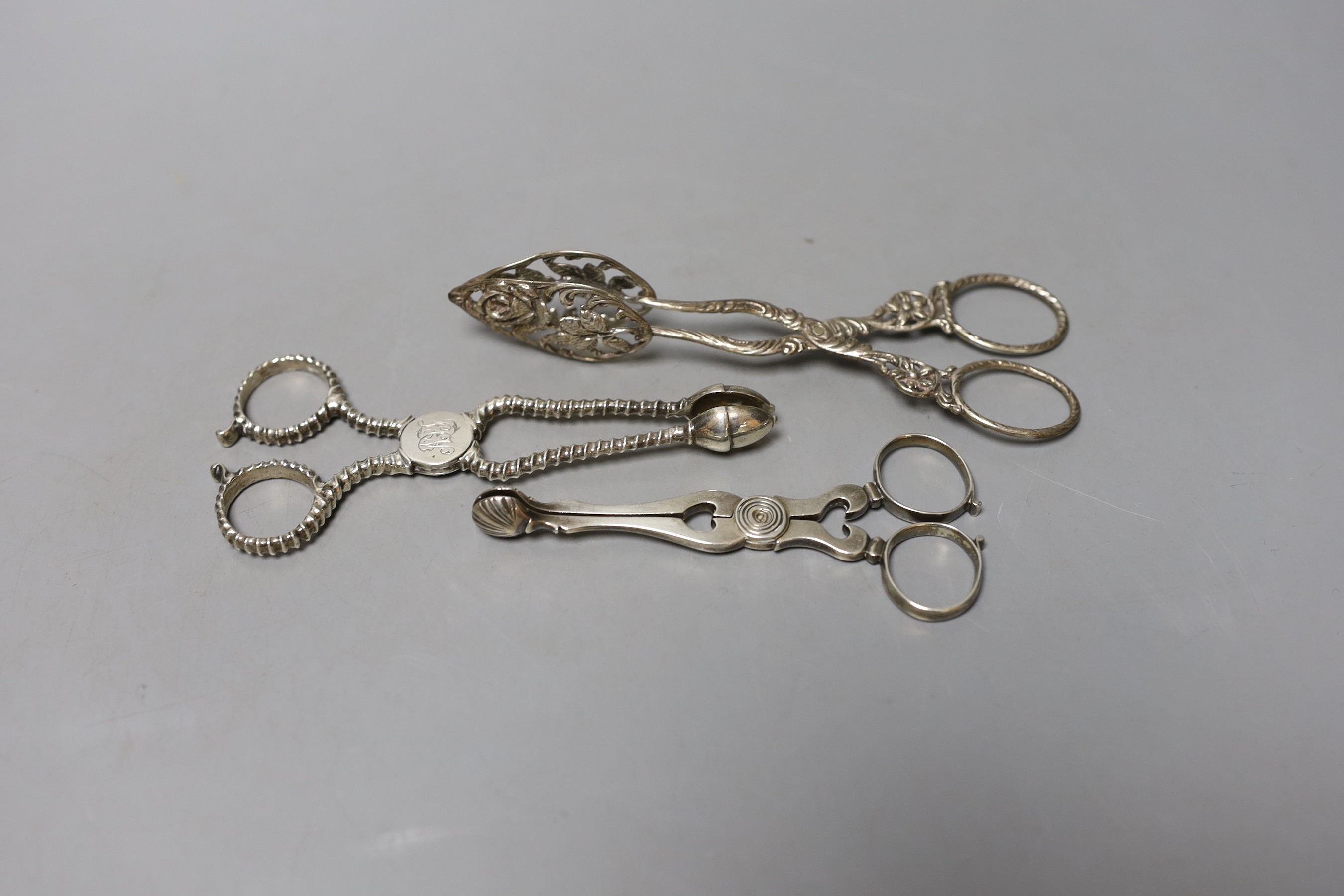 Two pairs of 18th century silver sugar nips, one with makers mark SW and one other later continental white metal pair, largest 14cm